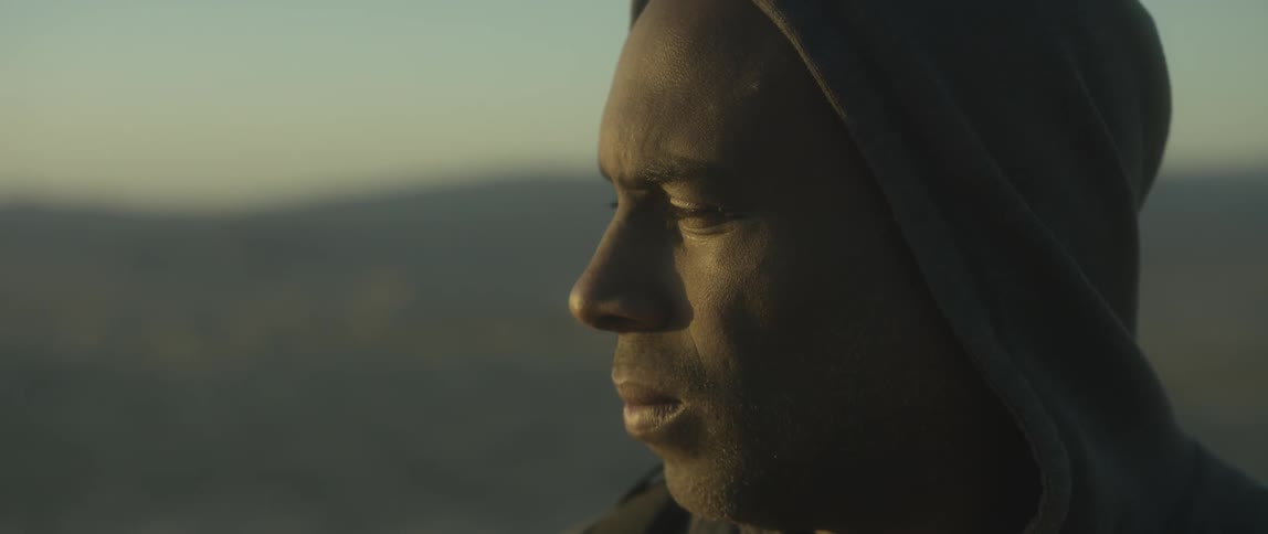 Close up of a man looking towards the sun