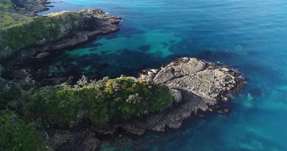 A coastal landscape is shown on a sunny day