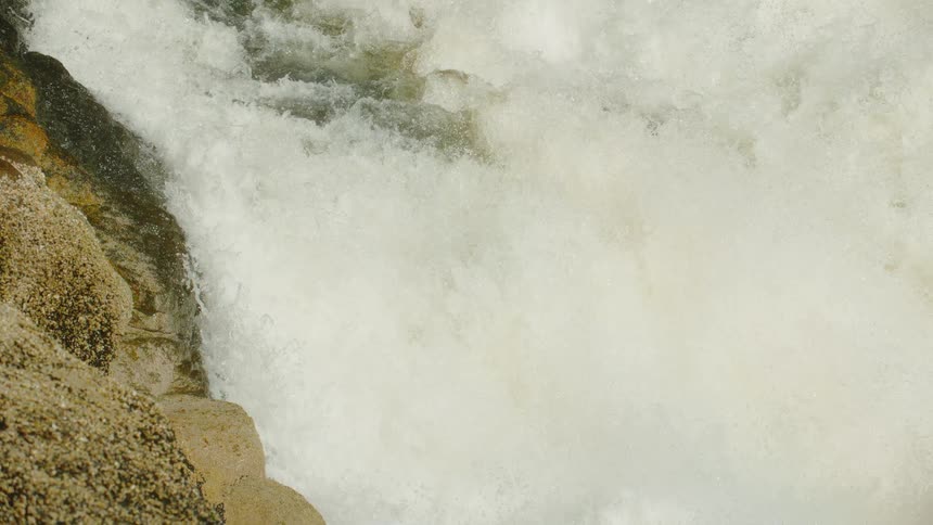 A waterfall over yellow rocks
