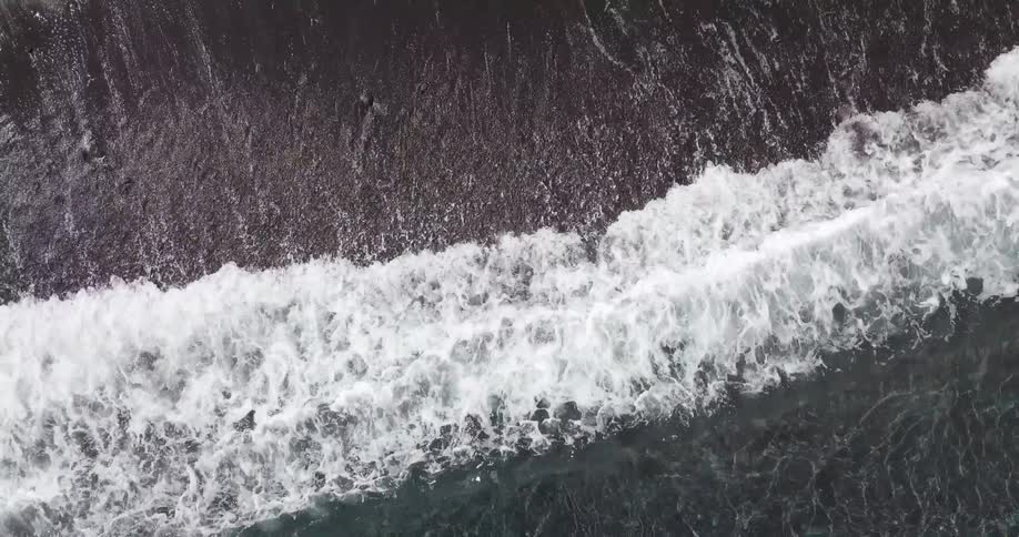 Ocean waves wash ashore a sandy beach