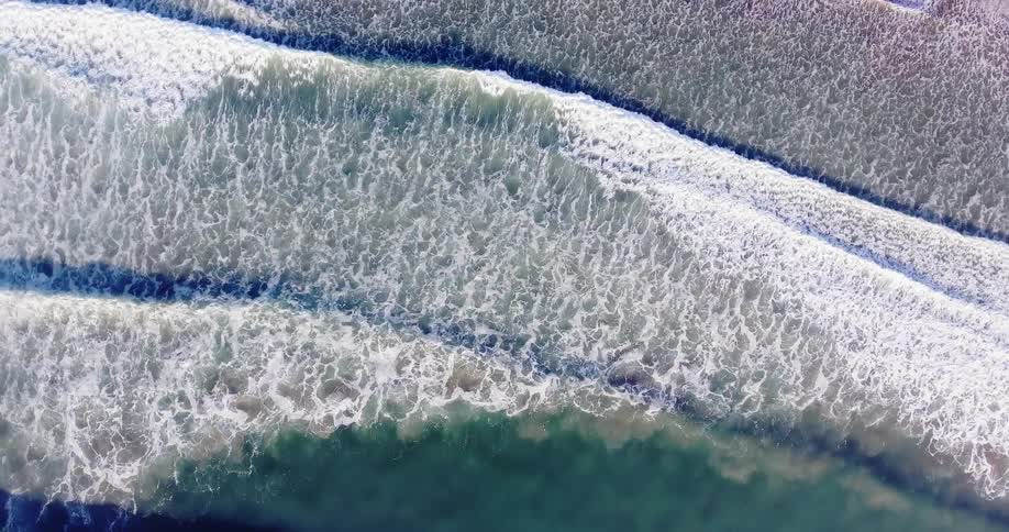 Waves roll onto a sandy beach