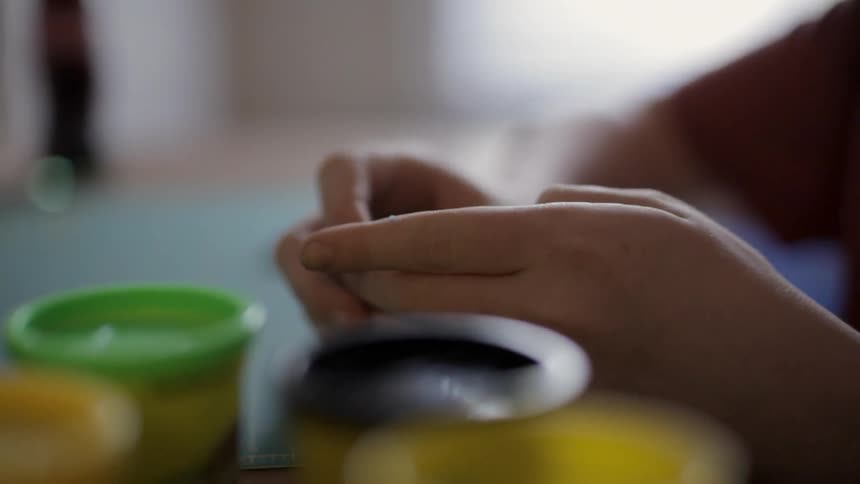 A person playing with clay