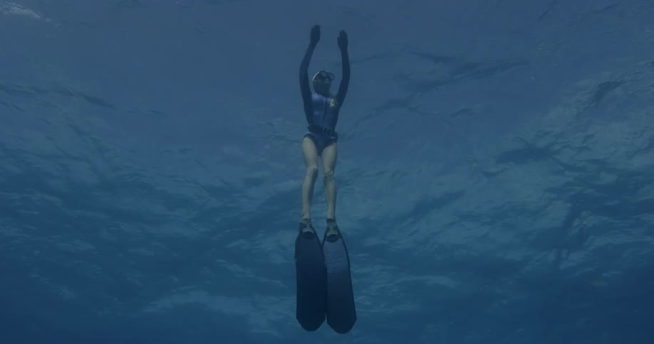 Diver floats upwards in the water