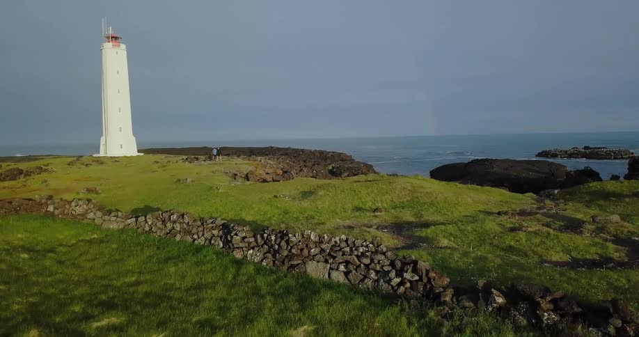 A lighthouse stands oceanside