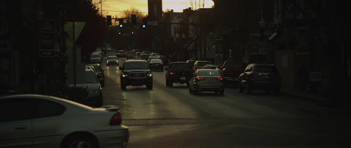 Cars are travelling down a city street