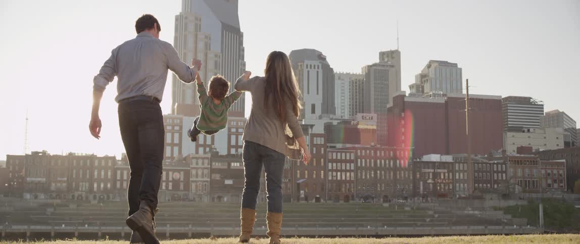 A couple swing their child