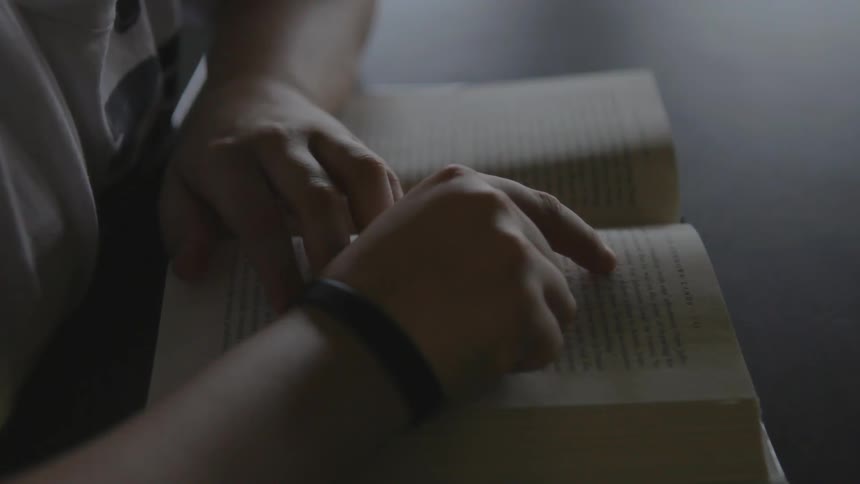 A child points at words in a book as they read