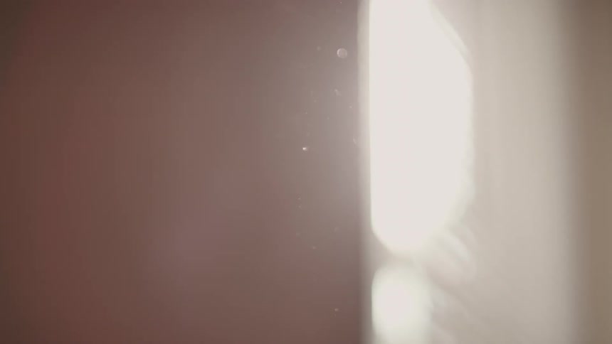 Close up of dust flying by a window