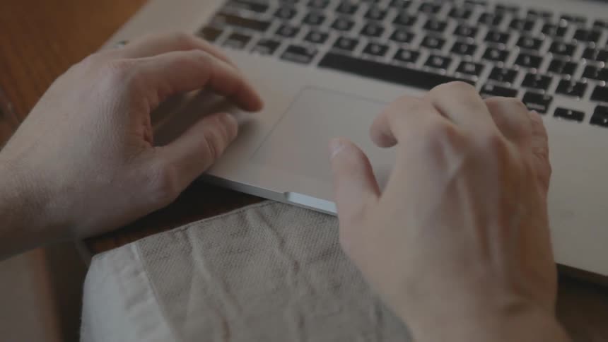 Man using trackpad on a laptop