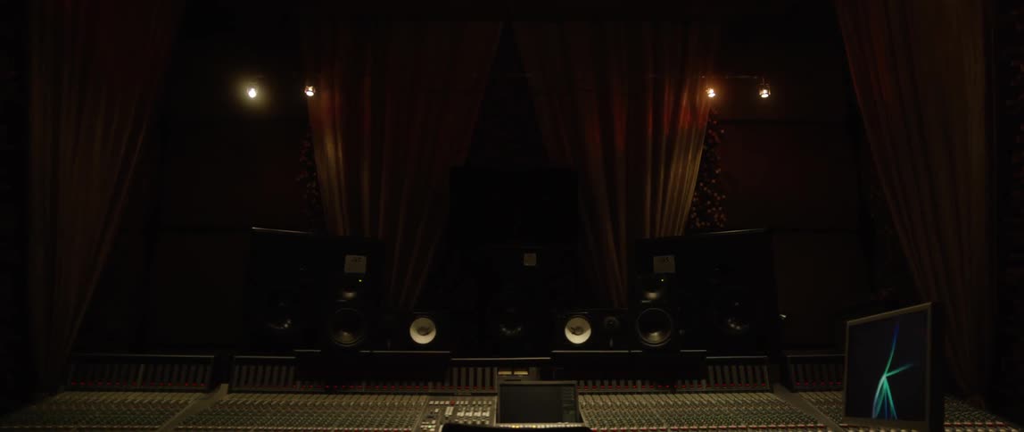 A dark recording studio with lights and room ahead