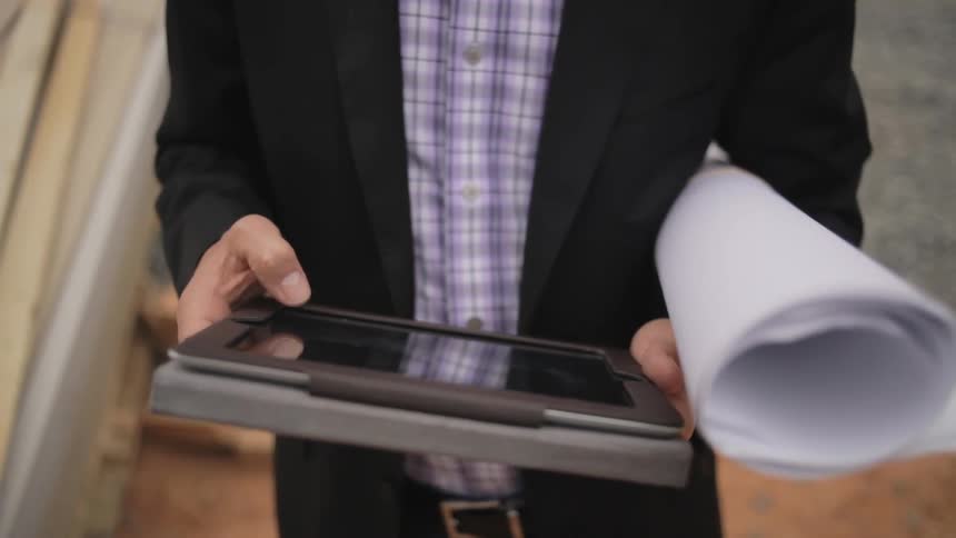 A person holding blueprints