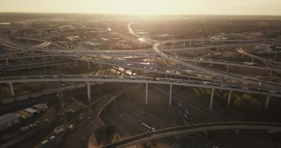 Cars drive on a city highway system