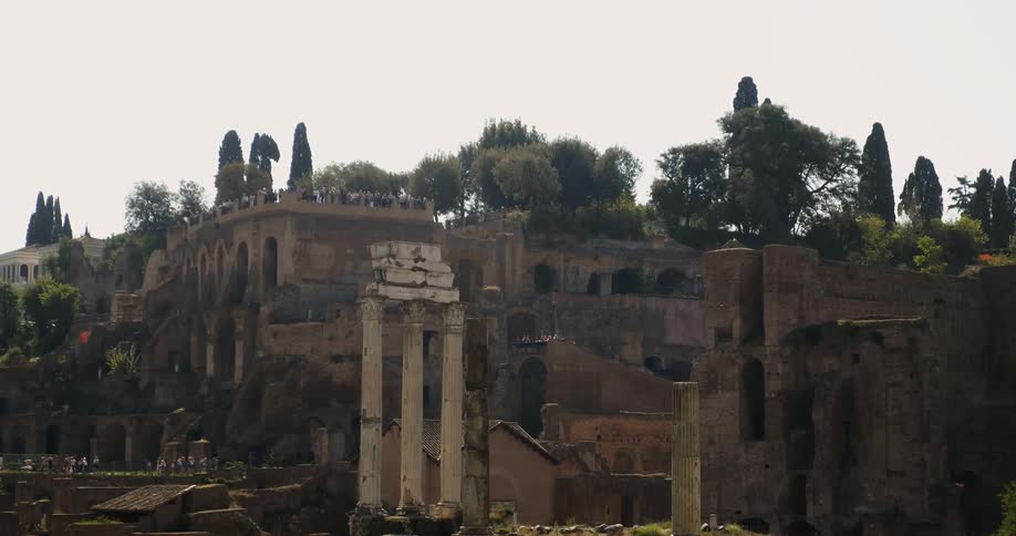 Tourists wander through a sprawling complex of ancient ruins