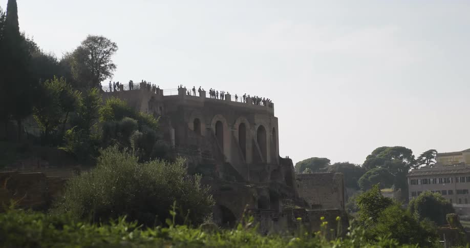 People lined up on a stone roof