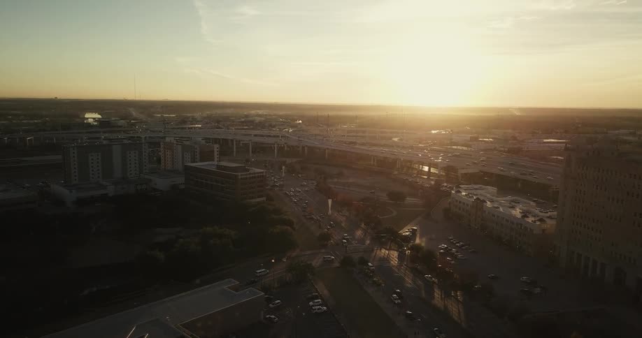 The sun rises over a busy highway