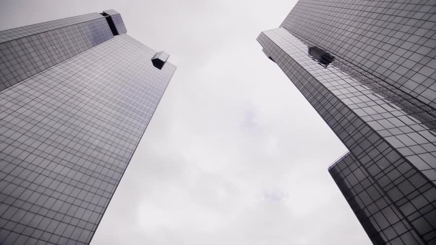 View looking up at two tall skyscrapers
