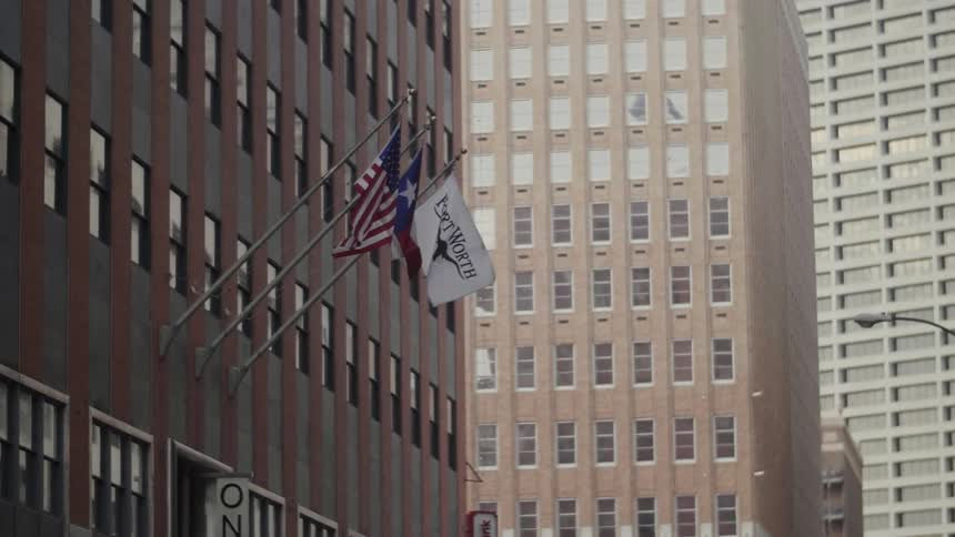 Flags hang from a city building