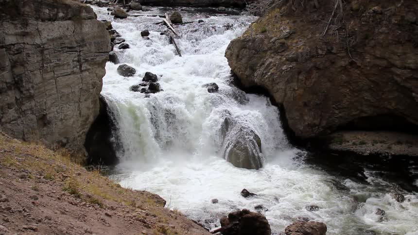 A stream has a small lip splashing water down