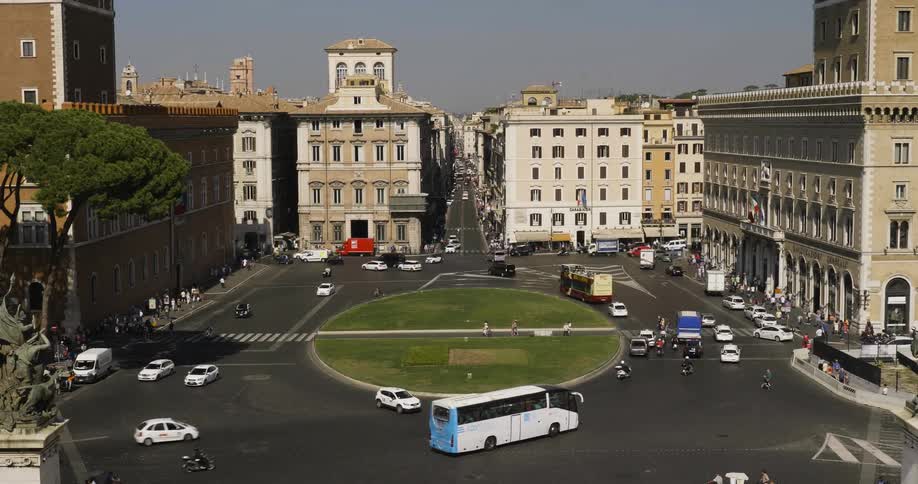 Cars drive on a city street