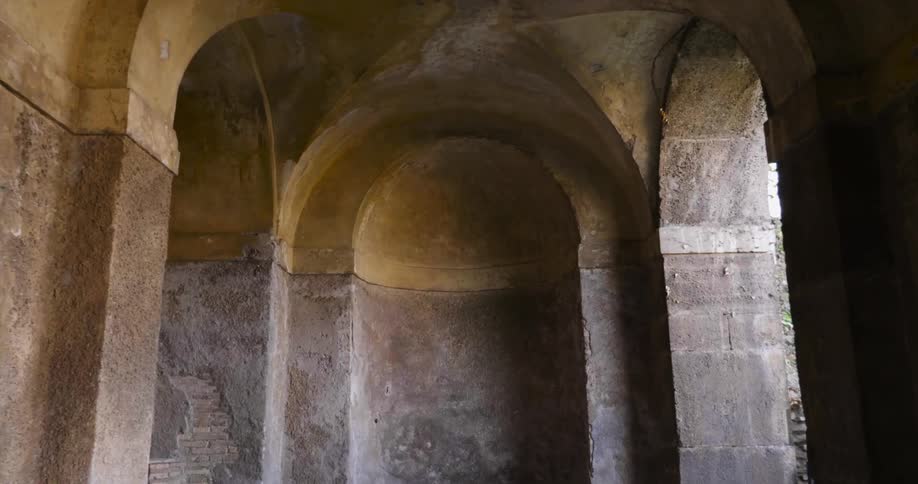 The arched ceiling of a stone building is shown