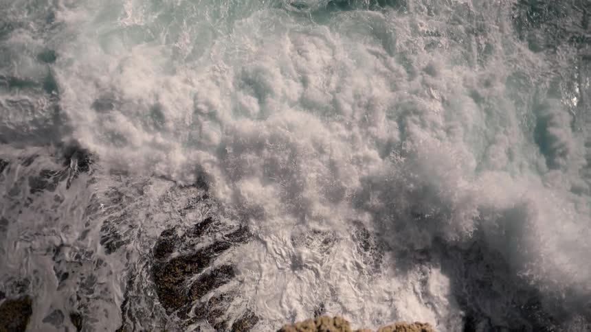 Ocean waves crash into the shore