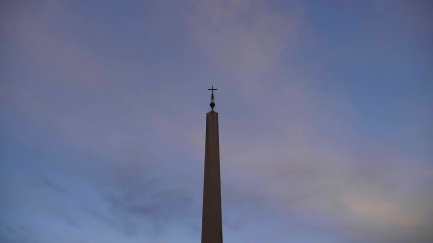 A cross on top of a long steeple