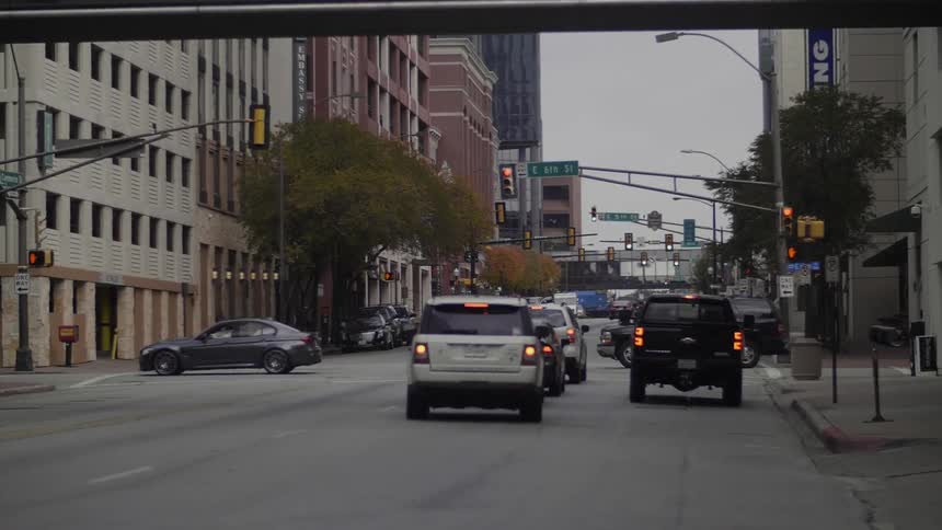 Cars drive on a city street