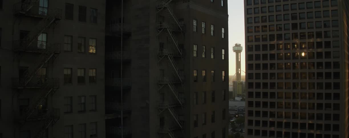 City buildings are shown at sunset