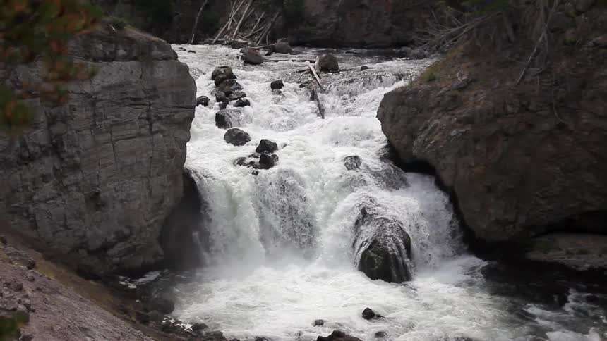 The rapids are moving over the rocks in this stream