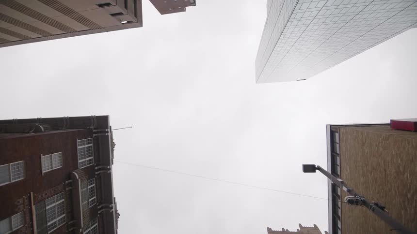 View looking up at buildings on a cloudy day