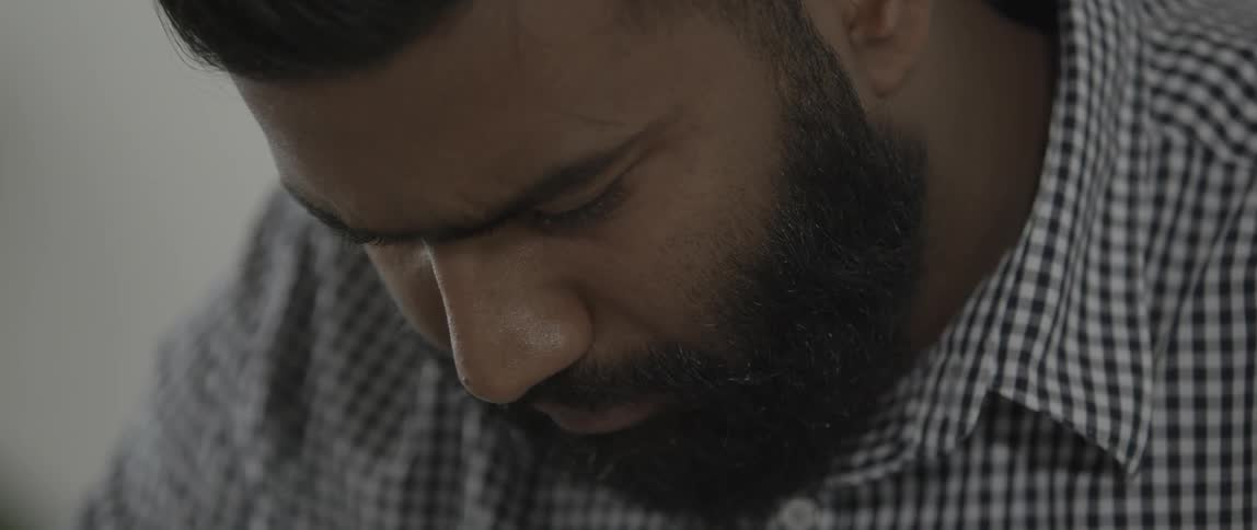 Bearded man looks down