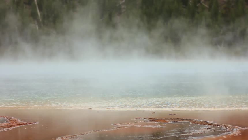 Steam slowly rises from the spring water
