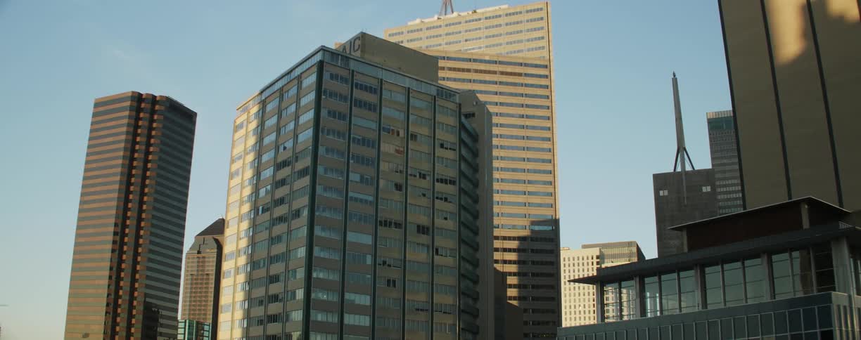 A city building is covered with glass and windows