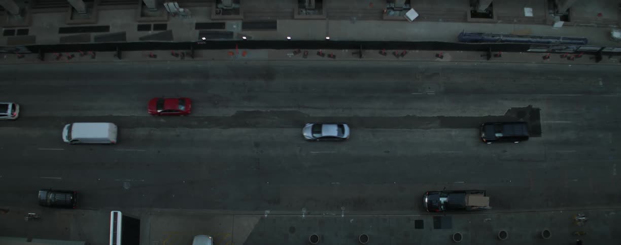 Cars drive on a city street