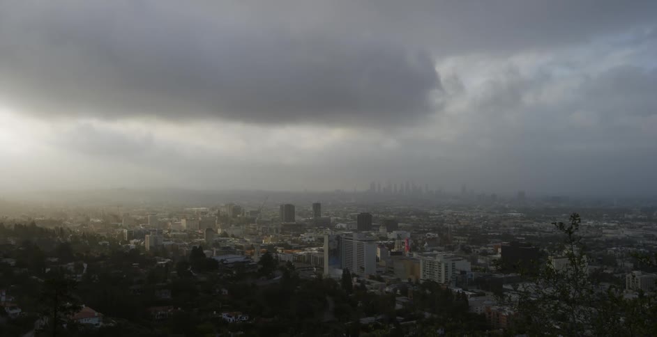 Clouds hover over city buildings