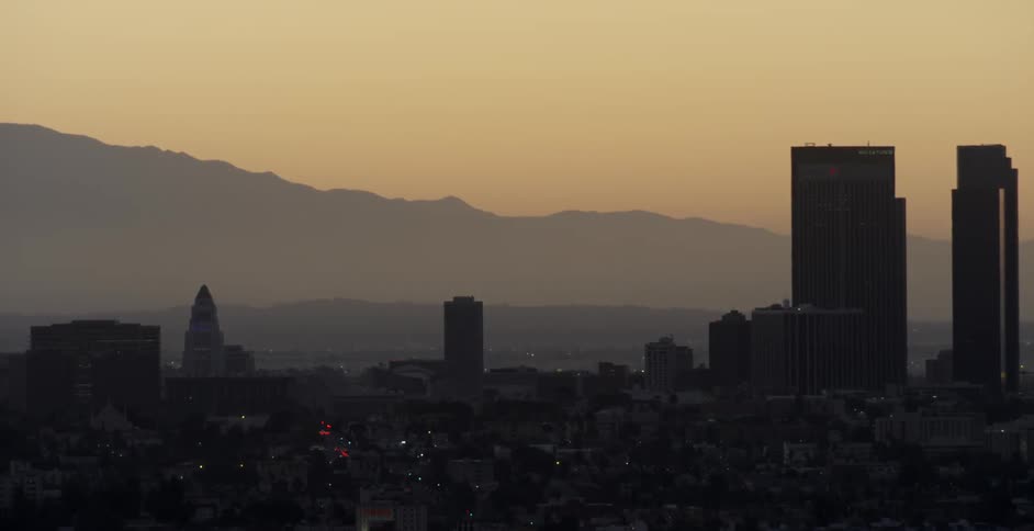 A cityscape is shown at sunset