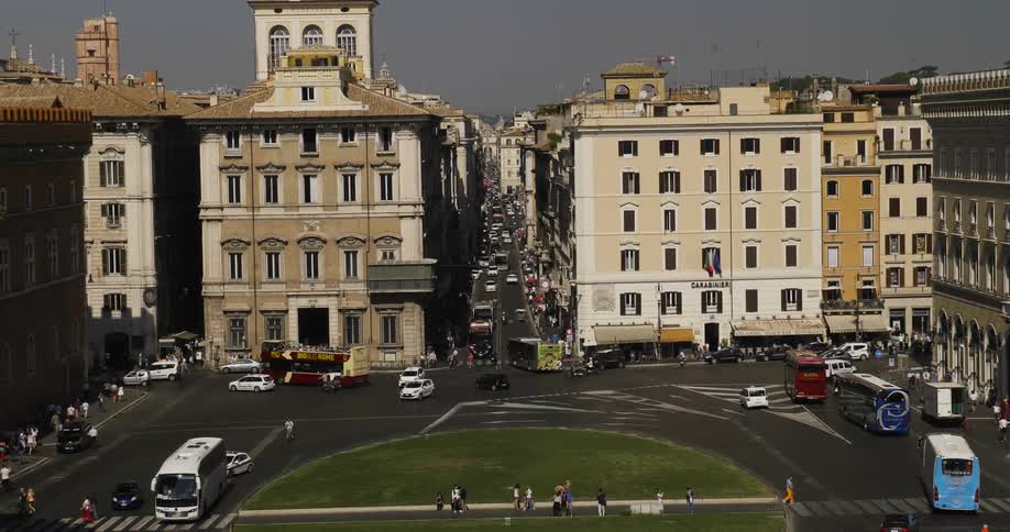 Cars drive on a city street