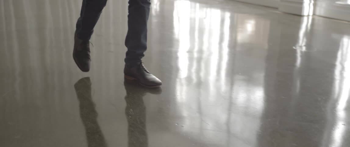 A man walks on a finished concrete floor