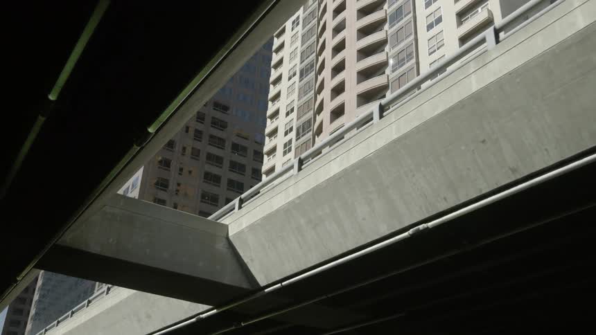 View looking up through a bridge to skyscrapers