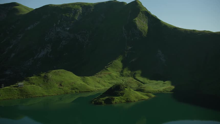 A lake has calm water near a mountain