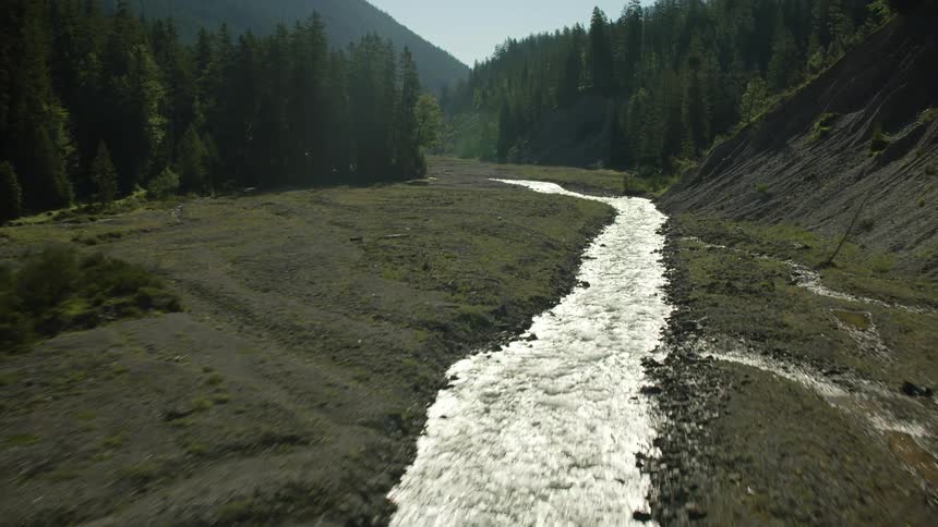A stream runs through the valley on a clear day