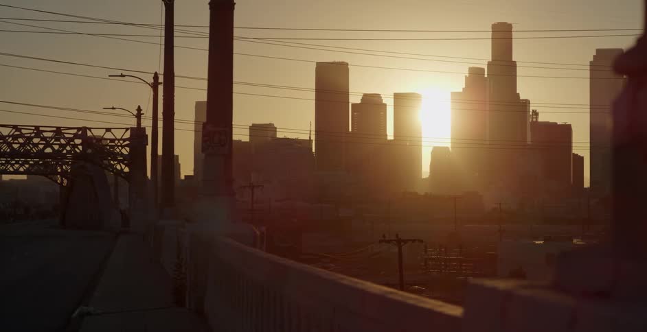 Sun shining through skyscrapers in a city
