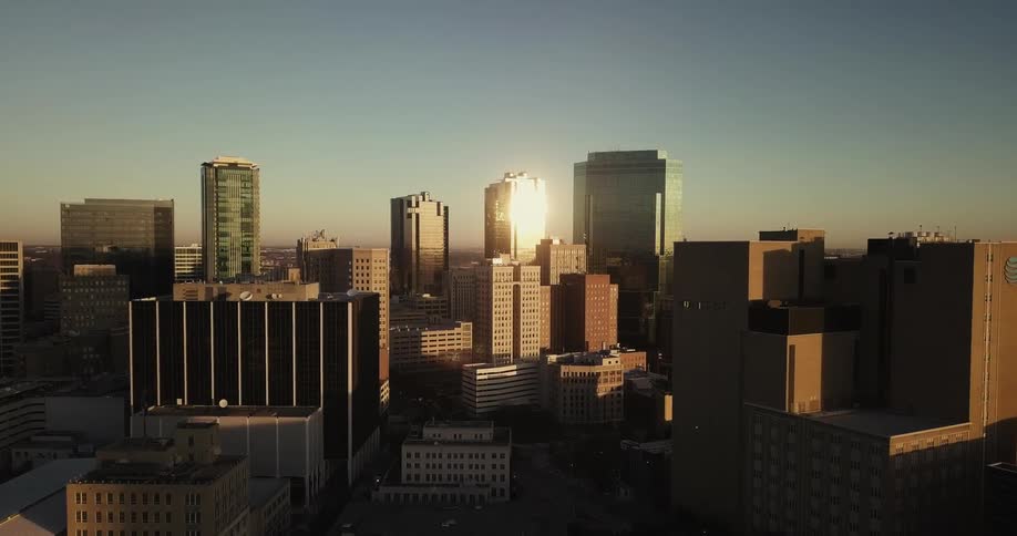 Sun reflects off a tall building in a city