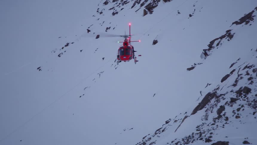 Helicopter drops explosive for avalanche control