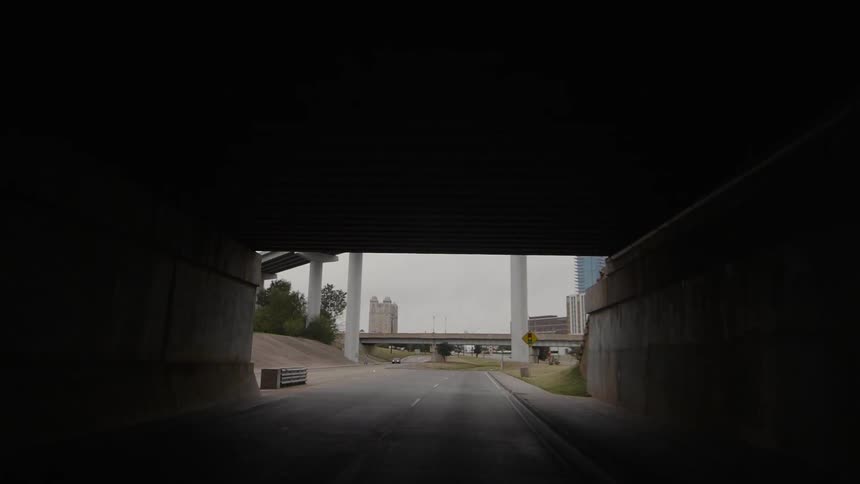View traveling out of a tunnel down a road