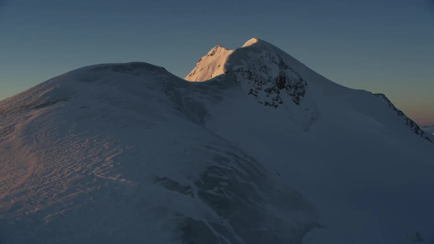 Snowy mountains at sunset