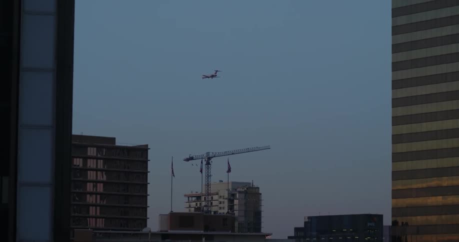 Airplane taking off over a city