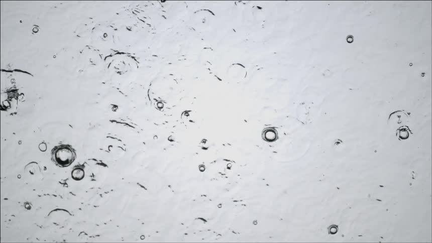 Rain causes ripples on a water surface