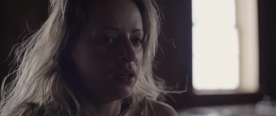 A woman is crying and looking down