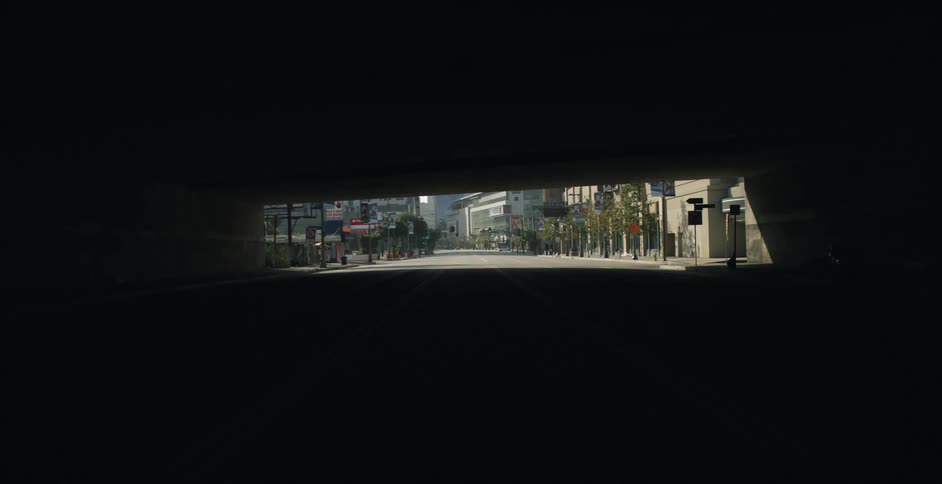 View of a tunnel looking out at city buildings